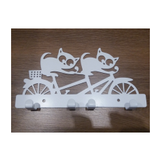 White metal hanger cats on bicycle